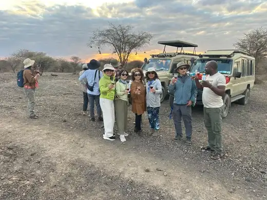 Guests enjoying sundowner drinks during a Serengeti safari in Tanzania