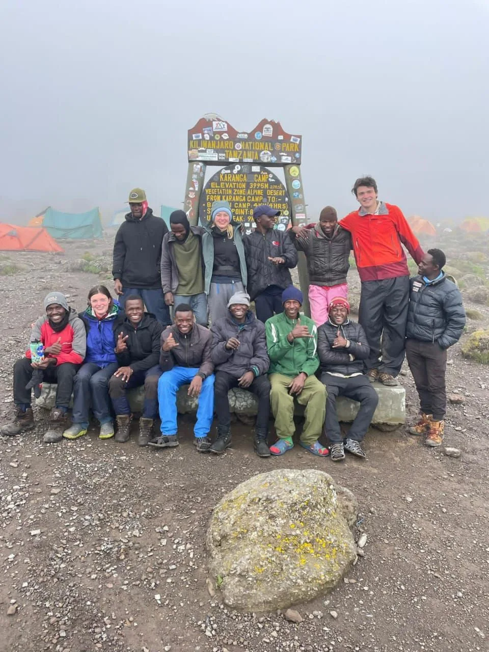 Climbers celebrating at Uhuru Peak on Mount Kilimanjaro